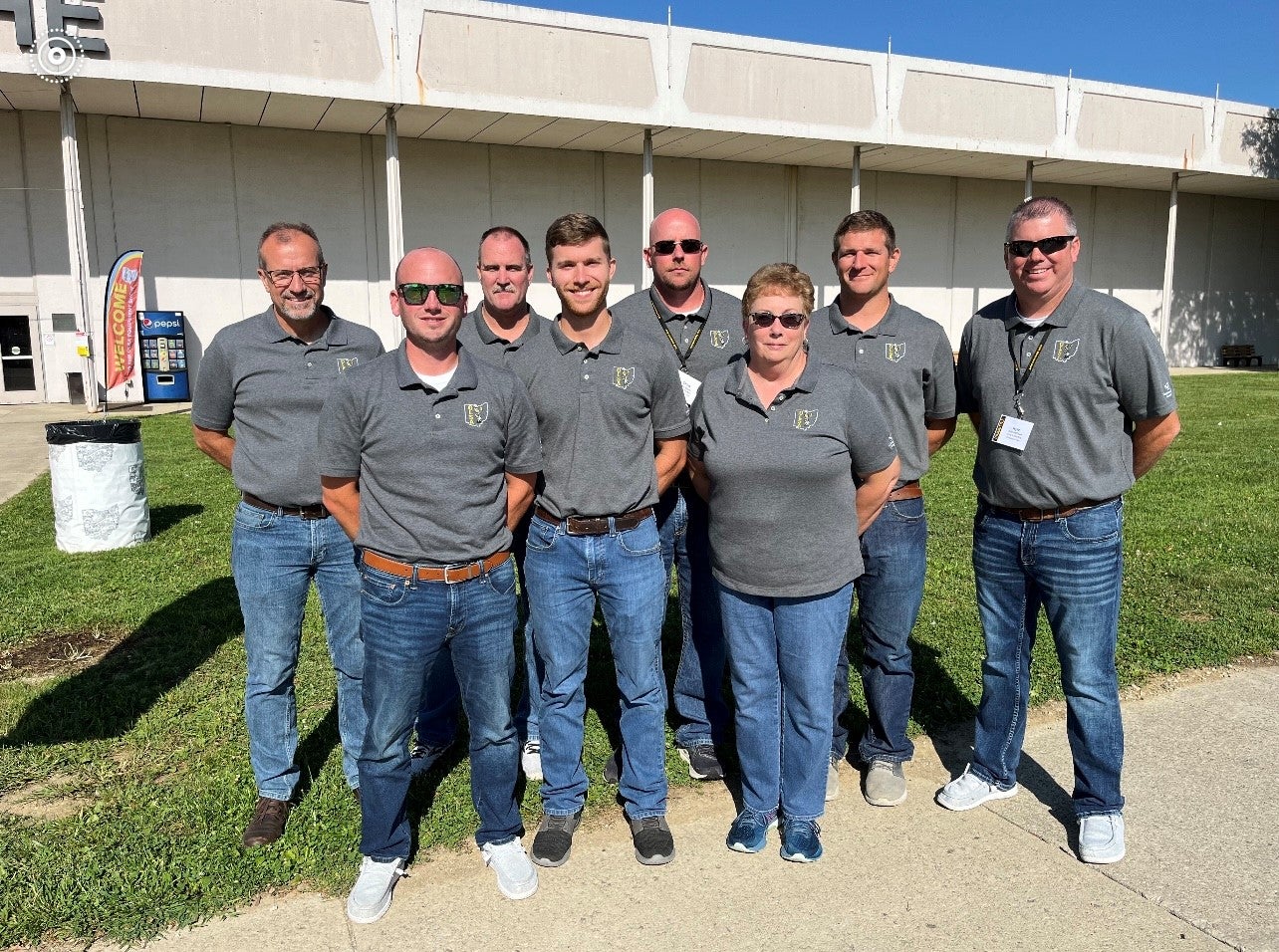 A group of people posing in front of a building