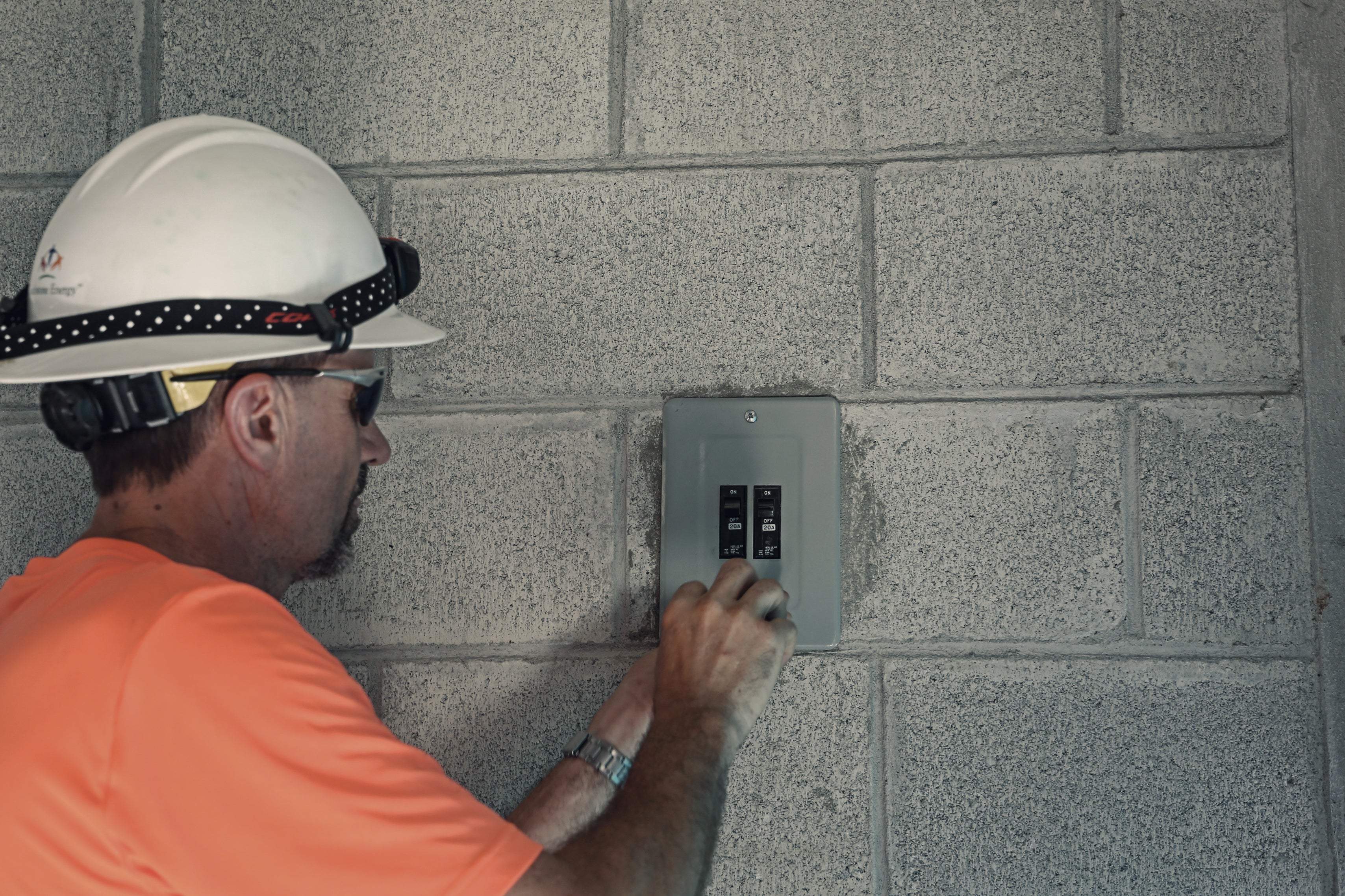 A man installing a light switch