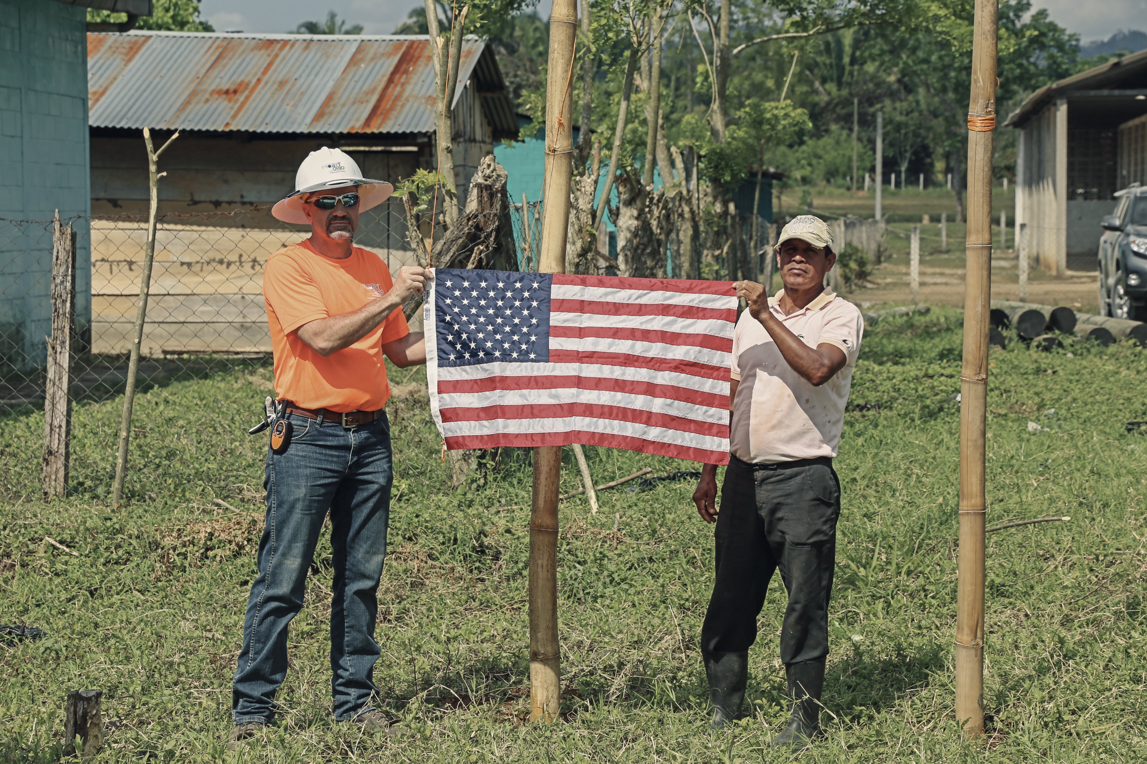 Two men holding an American flag