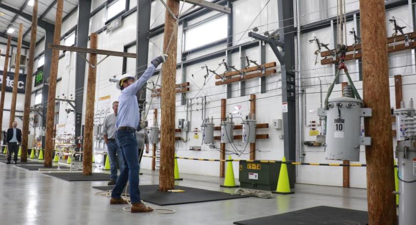 Rep. McClain learning to pull a transformer up a pole