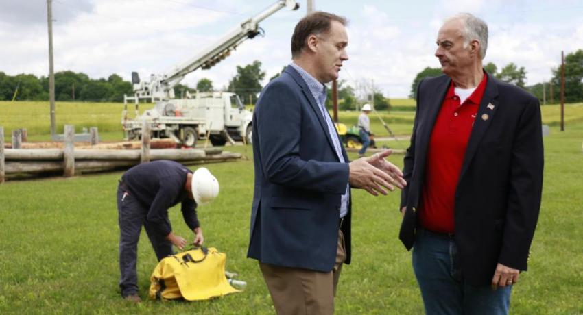 North Central Electric General Manager Ed VanHoose talking with Rep. Stein during a pole setting demonstration at COLT
