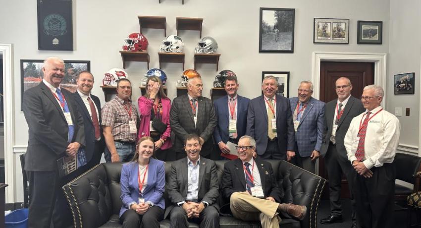 A group of people standing in a legislative building